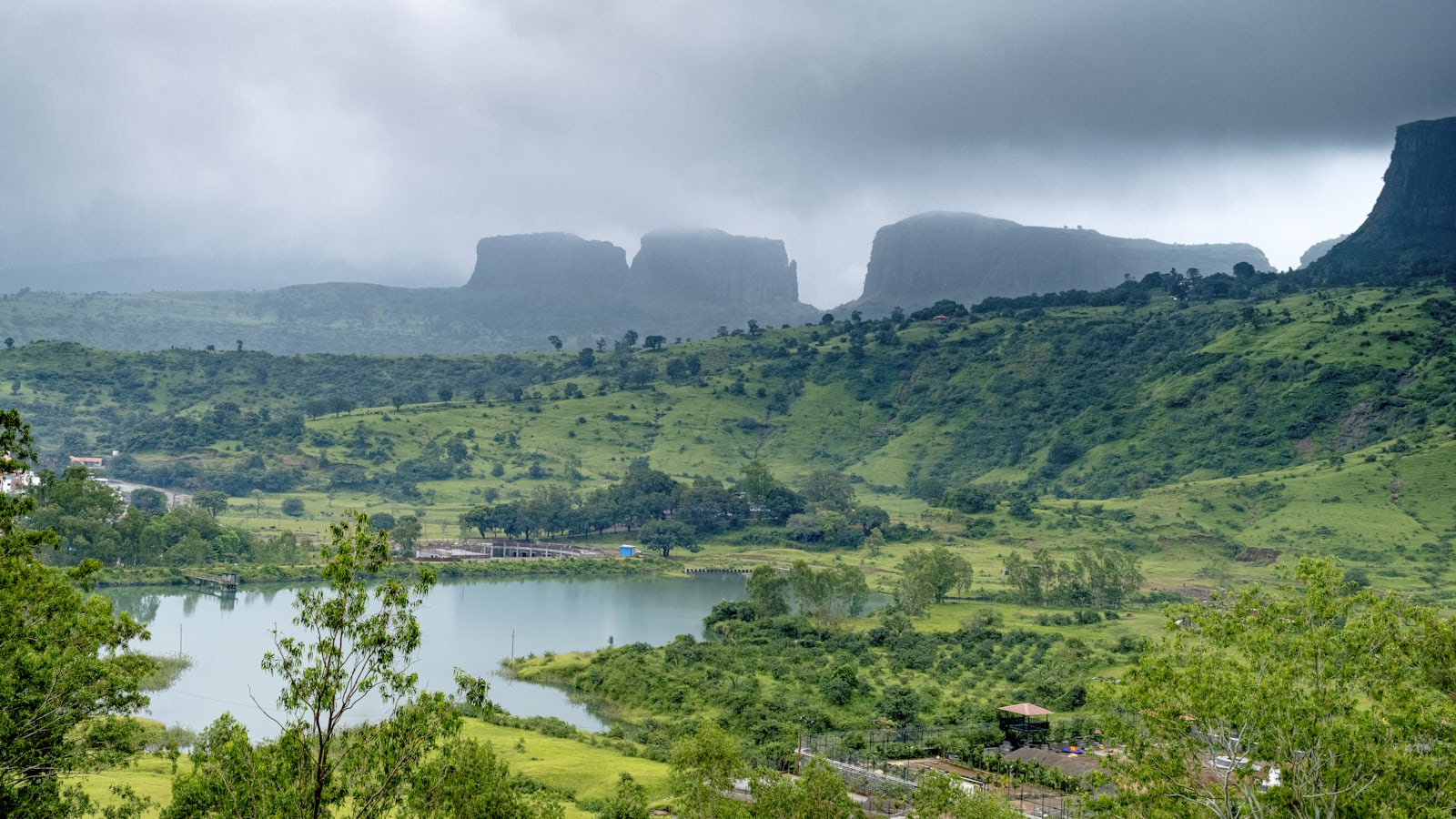 Green monsoon hills and a lake in the Trimbak range outside Nashik